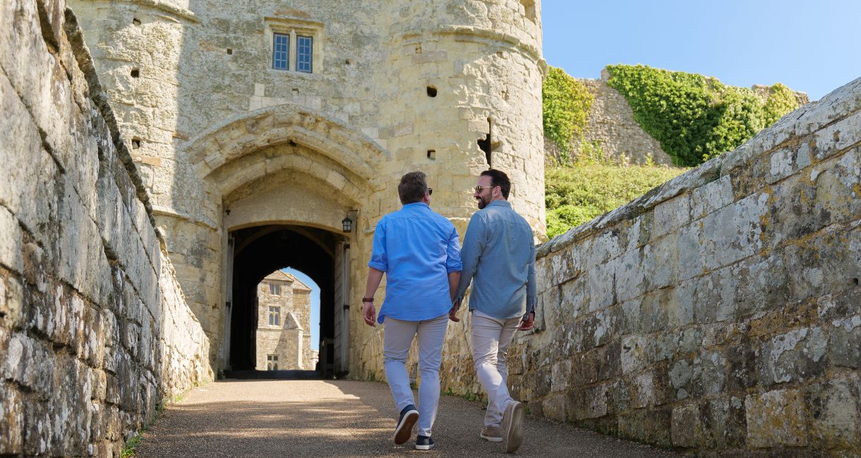 Couple walking through entrance at Carisbrooke Castle, Isle of Wight